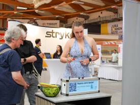 Besucher testen Geschicklichkeitsgerät an der hftm Diplomausstellung im Velodrom Grenchen